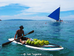 Selling coconut water to tourists under the heat of the s... by Jun Tagama 